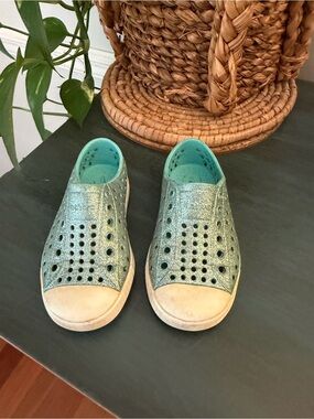 Native Jefferson bling slip on sneaker in teal color with white toe caps. C7